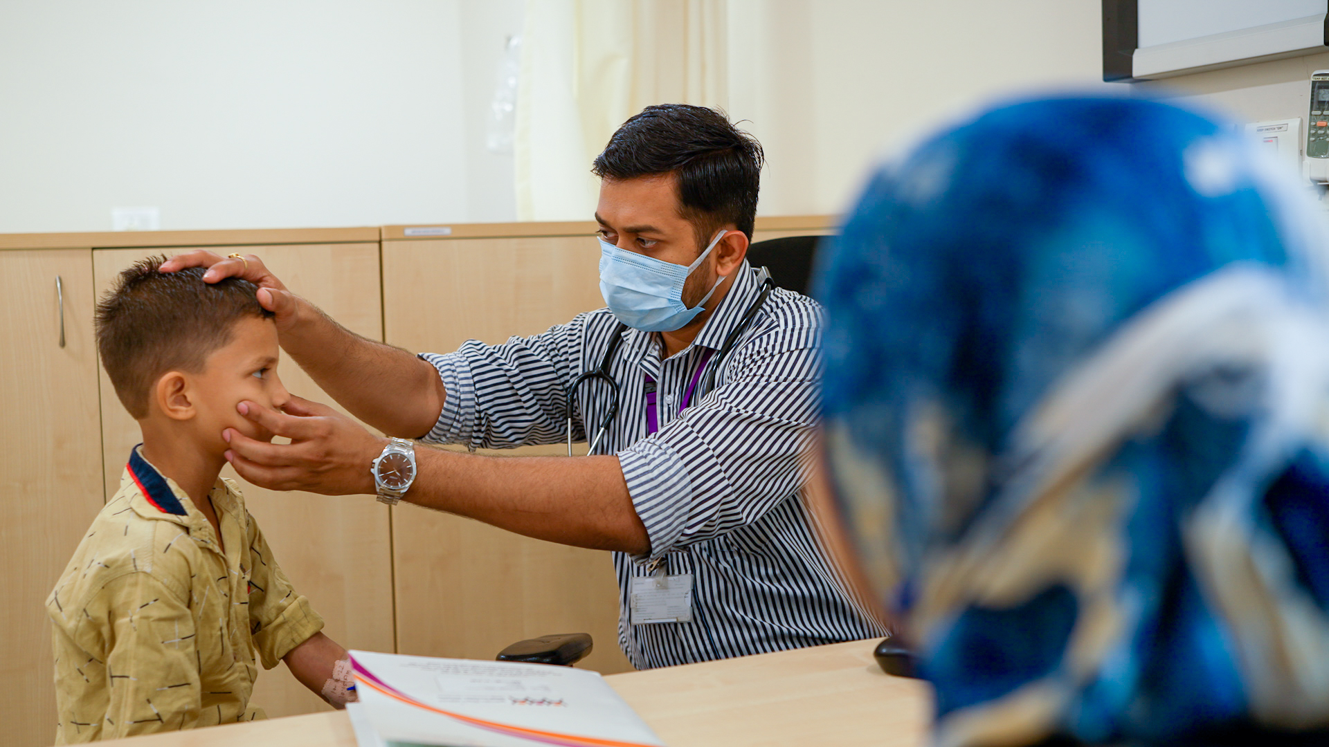 Healthcare professional examining a child